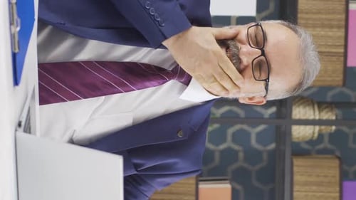 Stressed Man in Office at Desk