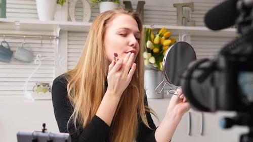 Woman Applies Lipstick for Beauty Vlog at Home