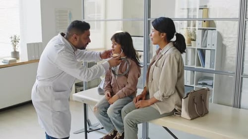 Friendly Doctor Examining Child with Stethoscope
