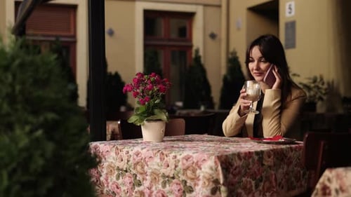 Stylish Woman Talking on Phone at Urban Cafe