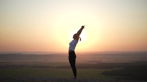 Young Woman Doing Yoga At Sunrise