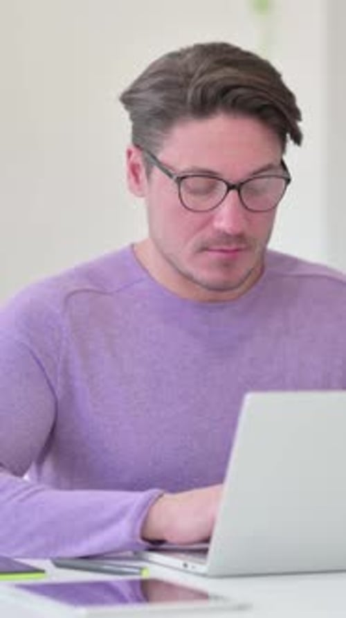 Man Working on Laptop Gives a Thumbs Up