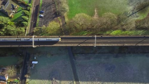 Fast Commuter Train Passing Over a Viaduct Bird's Eye View
