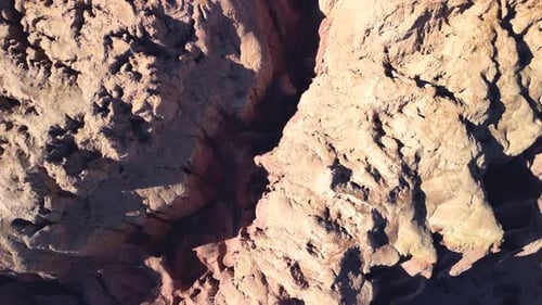 Aerial top view drone flying over scenic rocky mountains.