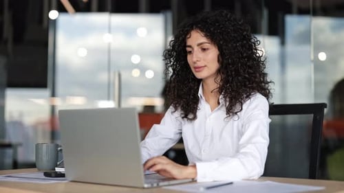 Businesswoman Working on Laptop in Modern Office