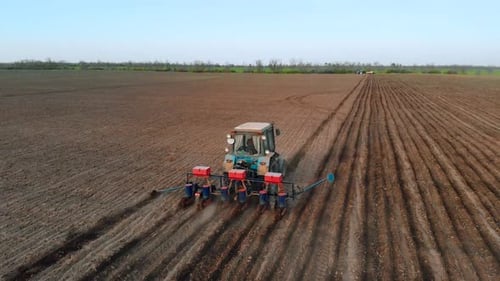Tractor Planting Crops in a Farm Field