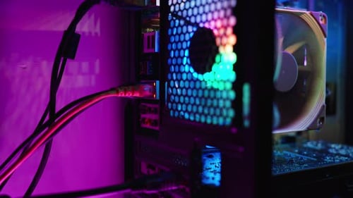 Desktop PC case with RGB lighting, the camera zooms in on the input of the Ethernet port.