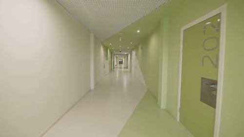 Numbered Classrooms in Brightly Lit Corridor in University