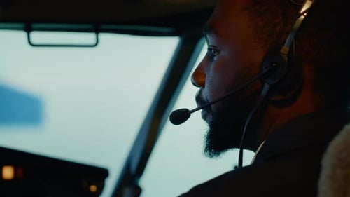 African American Copilot Preparing to Takeoff and Fly Plane