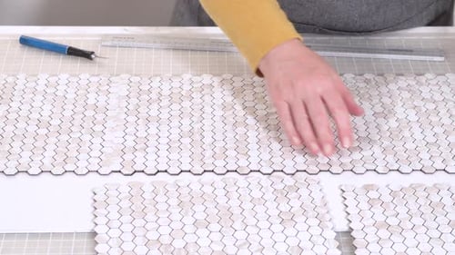 Hands Arranging Hexagon Tiles On Table