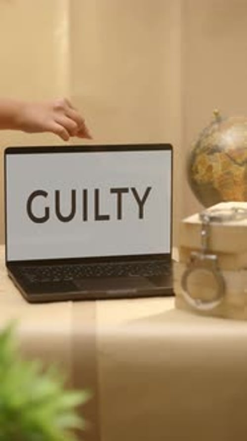 Laptop Displaying the Word Guilty