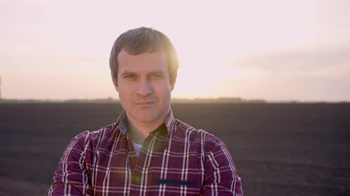Farmer Man Portrait Looking at Camera at Field Sunset Harvesting Crop Farming