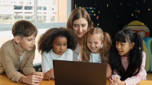 Caucasian teacher praised student while looking at learner work. Erudition.