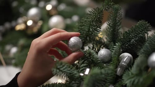 Decorating Christmas Wreath with Silver Ornaments Close Up