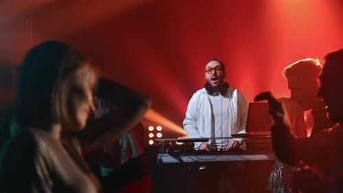 Male DJ Stage Live Performance Mixing Music Night Club Disco Party Nightlife Illuminated Flashlights