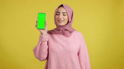 Happy Muslim Woman Holding a Mobile with a Chroma Screen