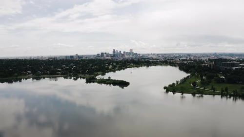 Drone shot pulling away from Sloan Lake with Denver, Colorado in the backdrop.