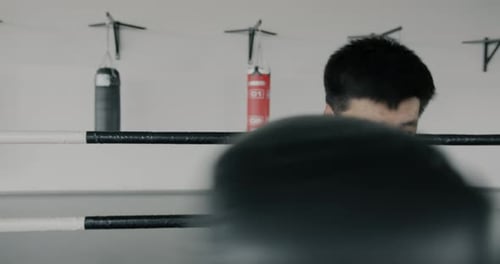 Determined Boxer Throws Punches in a Ring