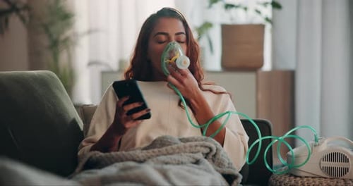 Woman Using Nebulizer While Using Smartphone