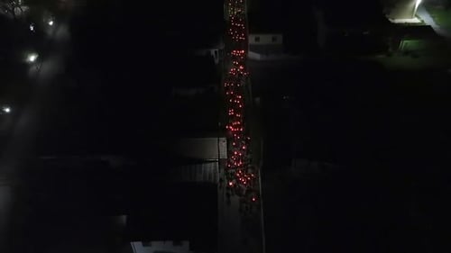 Night Time Procession of People Walking With Lights