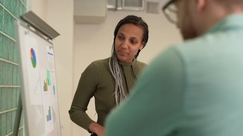 Woman Giving Business Presentation to Colleague