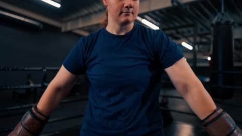 Boxer With Gloves Standing in Boxing Ring