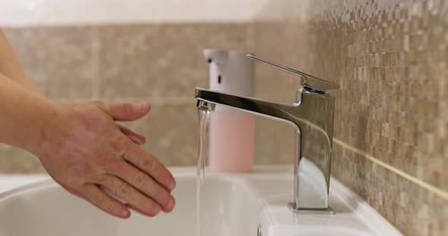 Washing Hands with Soap at a Bathroom Sink