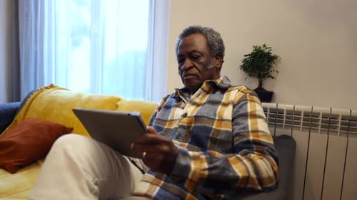 Adult Using Tablet Device at Home