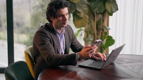 a serious businessman working on a laptop in the office checking the fall of the stock market