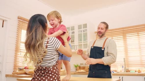 Family fun in bright kitchen with young child