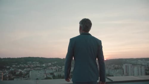 Close Up Back View of Young Business Man in Suit Standing Feel Freedom Raises Hands on Roof Top at