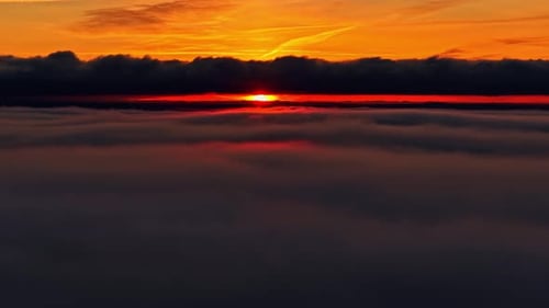 Dramatic Aerial Sunset Above Clouds with Vibrant Colors