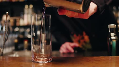 Bartender Make a Cocktail for Guest in the Bar Pink Icy Alcohol Drink with Bubbles Barman is Doing