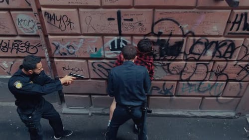 Tense and Thrilling Urban Confrontation in a GraffitiLaden Alley of the City Streets