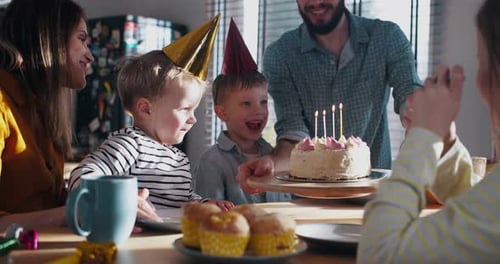 Family Celebrating Birthday at Home with Cake