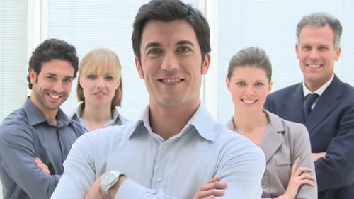 Smiling Group Of Business People Standing Together At Office With Leadership In The Foreground. ...