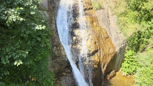Beautiful Waterfall Cascading Down Rocky Cliffside