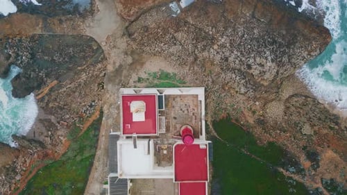 Top View Coastal Lighthouse on Ocean Cliffs Beacon Placed on Rocky Seashore