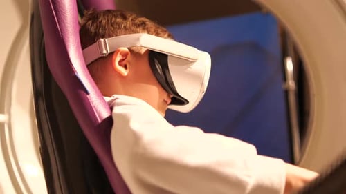Boy Wearing VR Headset Sits in Purple Chair
