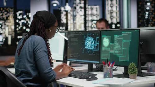 Panicked Female Engineer in Office Requests Help From Colleagues to Block Hacker