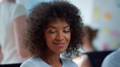 Portrait of a happy mixed race businesswoman smiling in a modern office