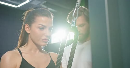 Portrait View of the Strong Healthy Tired Women Doing Push Ups While Training Arms with Trx Fitness
