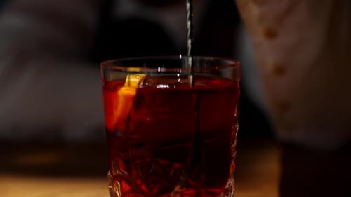 Bartender Prepares Elegant Cocktail in Faceted Glass