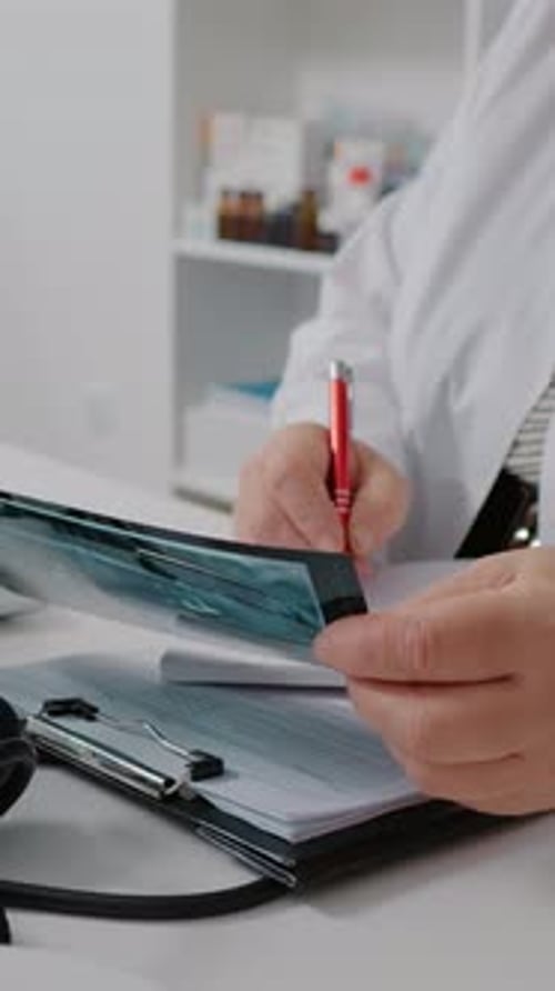 Doctor Analyzing X-Ray in Clinic Office