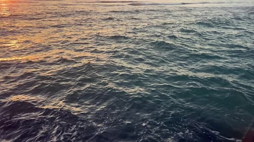 water clip with waves, sea, ocean, river, lake or lagoon with wind and the reflection of the sunset