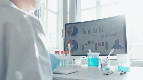 Scientist Typing Data at Bright Lab Desk