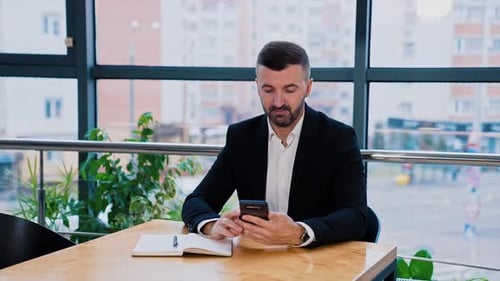 Man Using Smartphone in Modern Urban Office