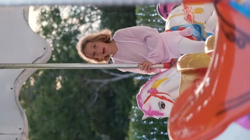 Child Girl Enjoying Carousel Ride Horse at Park