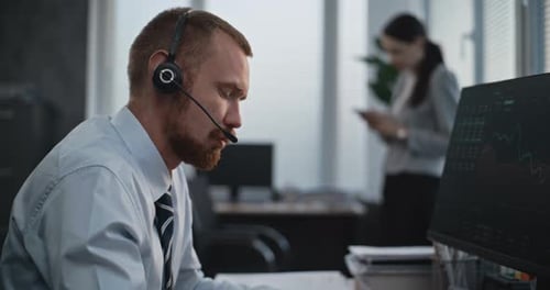 Financial Specialist Works on Computer Talks to Clients Monitors Share Markets Takes Notes