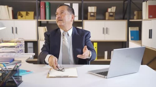 Angry Man at Office Desk with Laptop